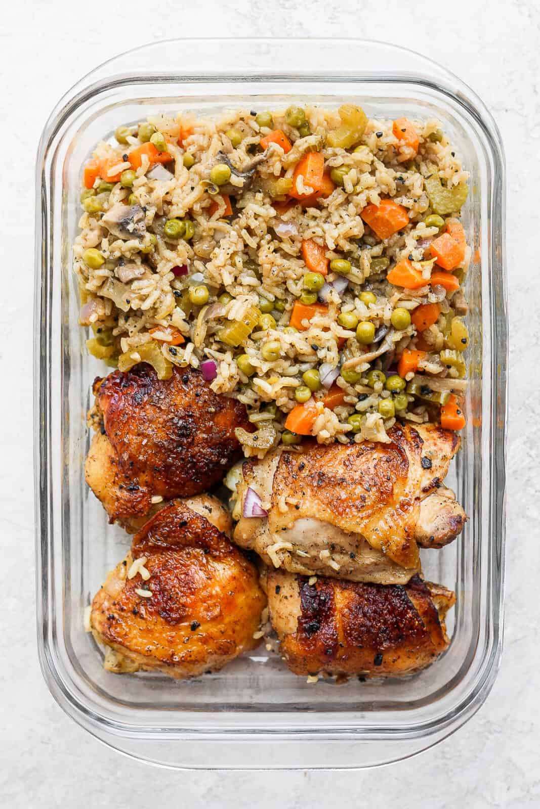 Baked chicken and rice in a storage container.