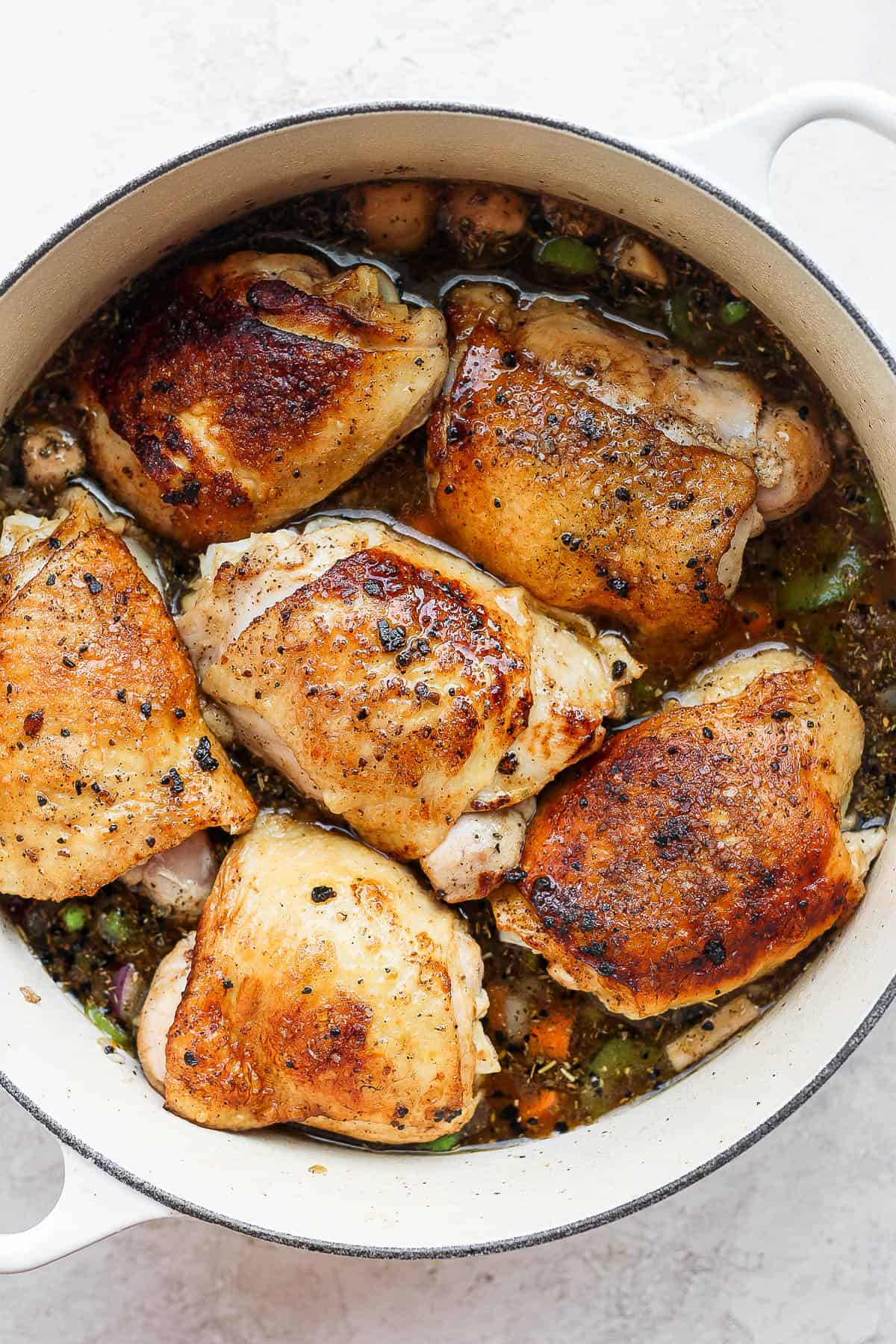 Baked chicken and rice in a dutch oven before baking.