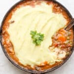 Cast iron skillet filled with a shepards pie.