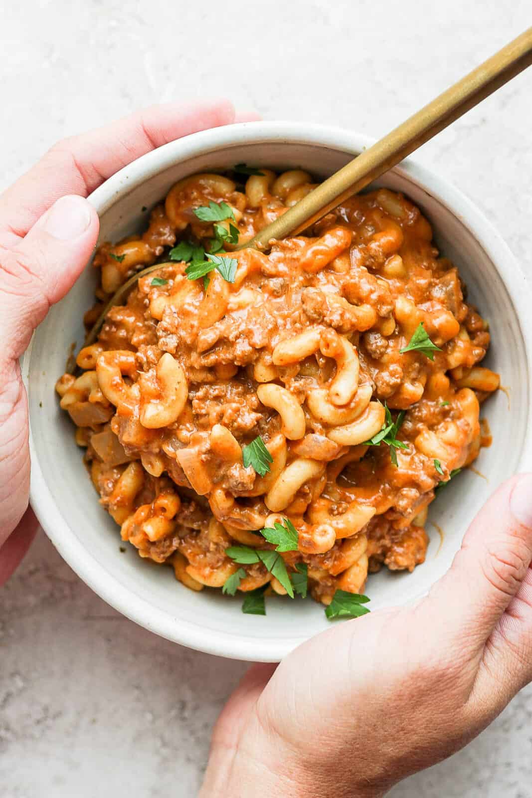 Healthy hamburger helper in a bowl with a spoon.