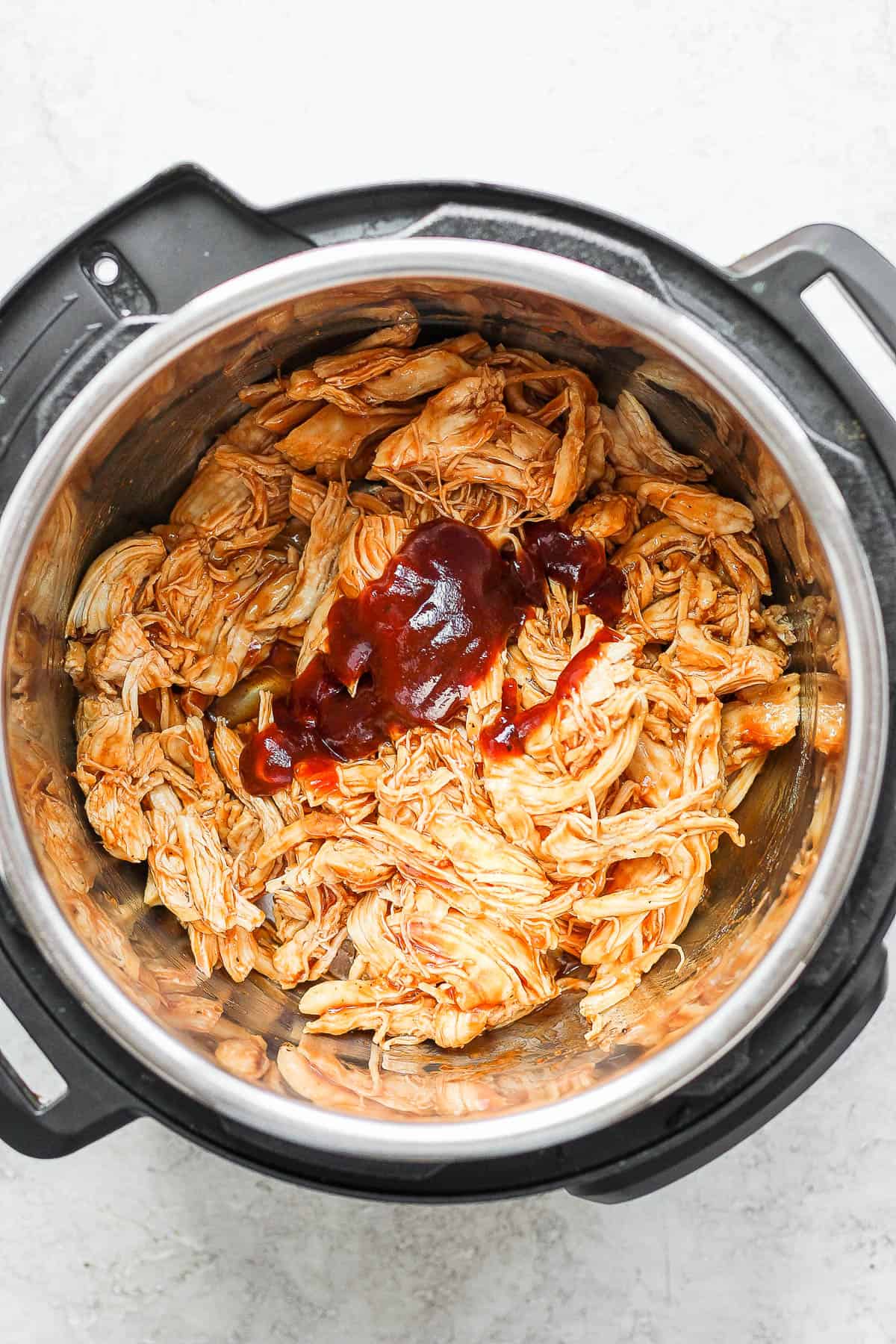 Top shot of shredded bbq chicken in an Instant Pot.