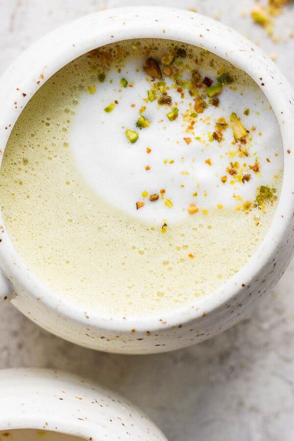 Mug full of a pistachio latte.