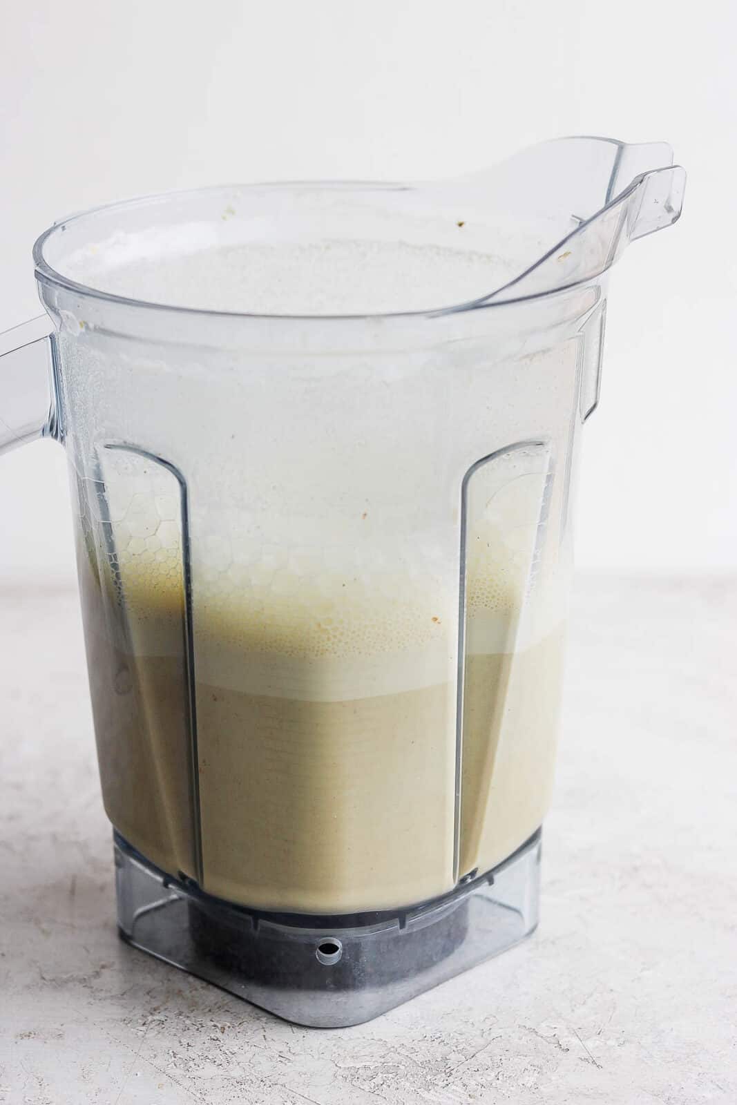 Blended pistachio milk in a blender.