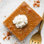 Plate with piece of a pumpkin pie bar on it.