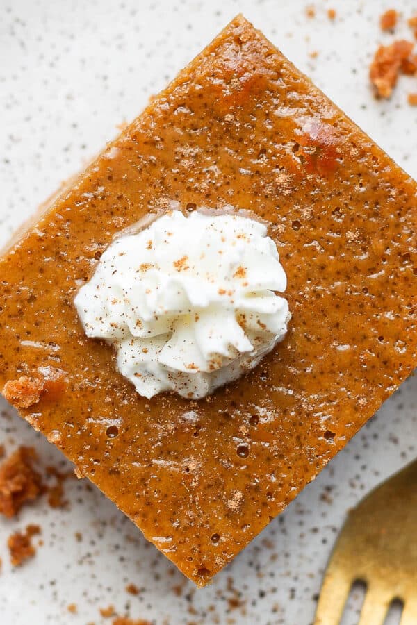 Plate with piece of a pumpkin pie bar on it.