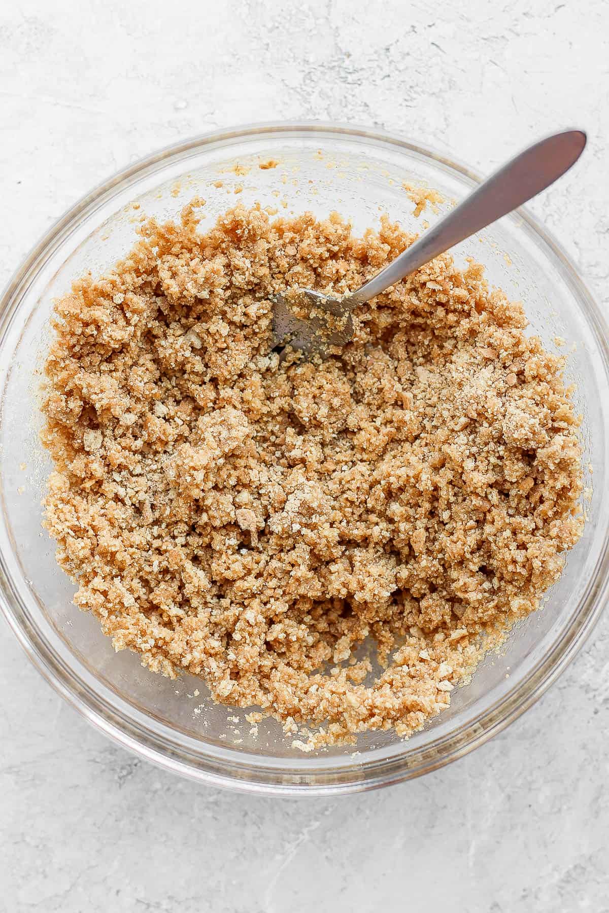 A bowl with graham cracker crust ingredients.