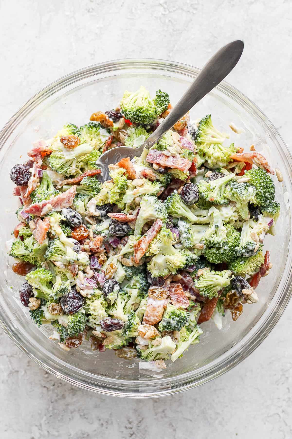 Broccoli bacon salad all mixed together in a large bowl.