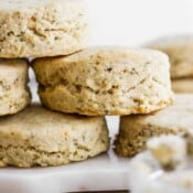 Several gluten free herby biscuits stacked on top of each other.
