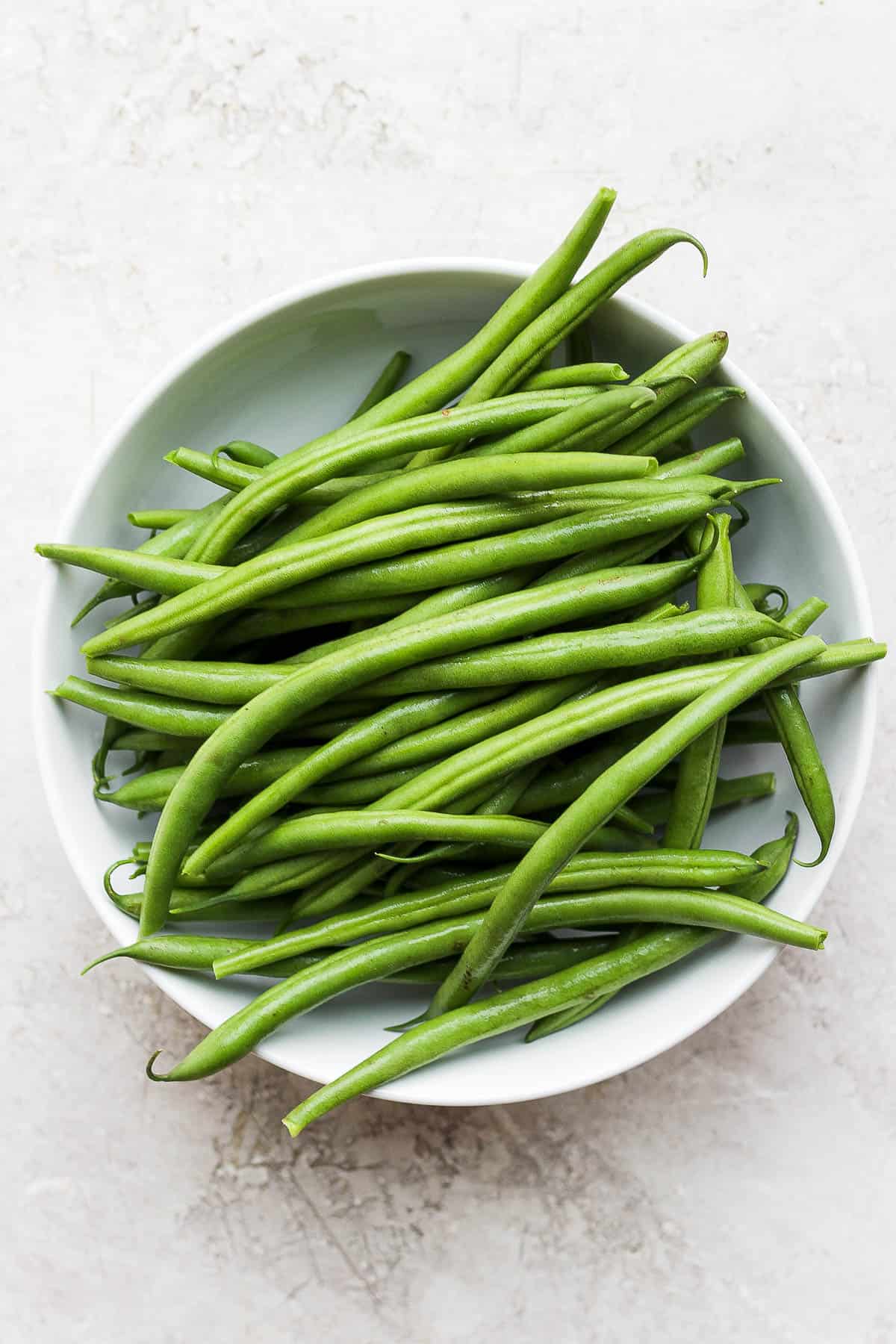 Washed and trimmed green beans in a bowl.