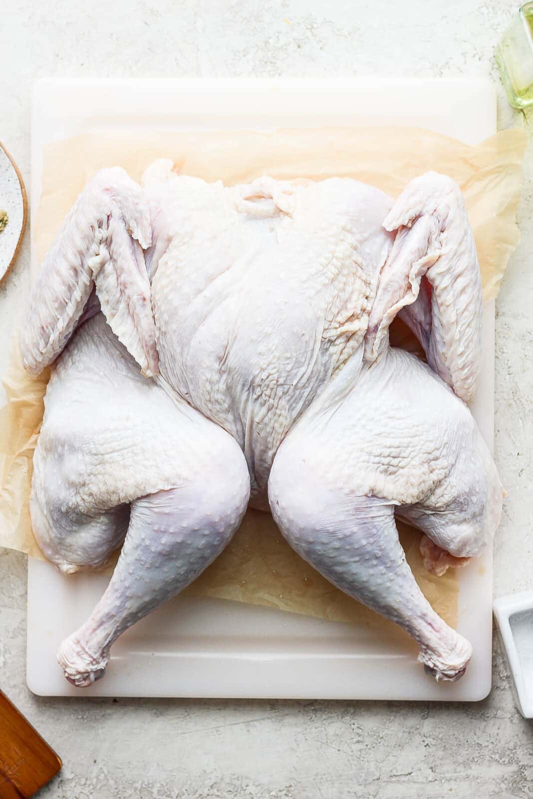 A spatchcock turkey on a cutting board.