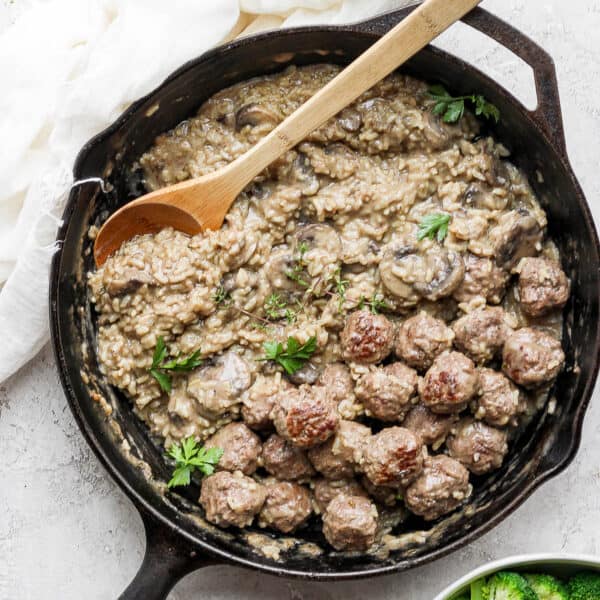 Skillet filled with creamy meatballs and rice.