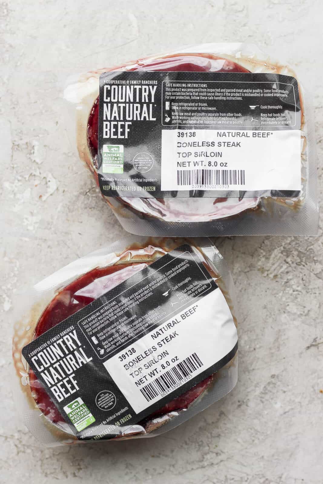 Two packages of Country Natural Beef boneless steak top sirloin.