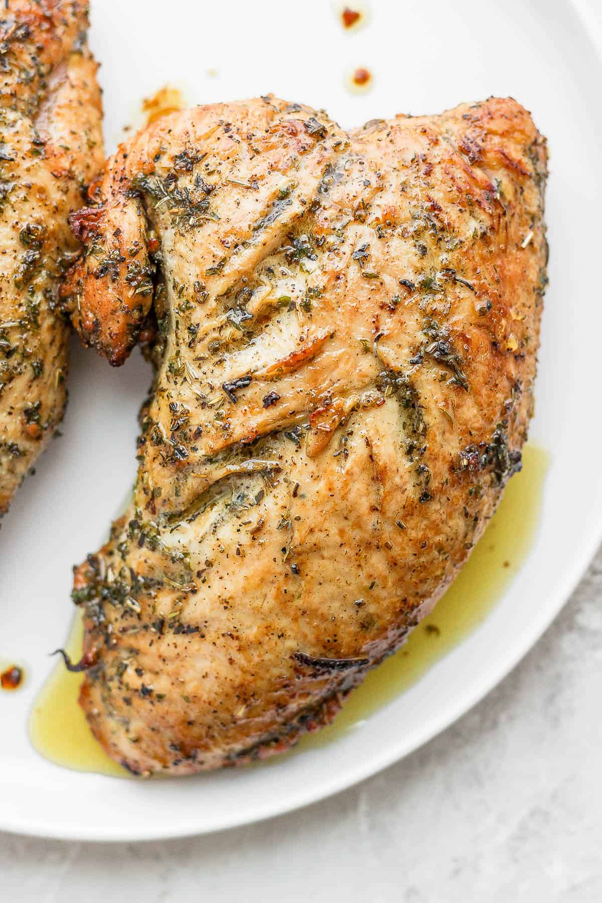 Seasoned turkey tenderloin on a plate after being cooked.