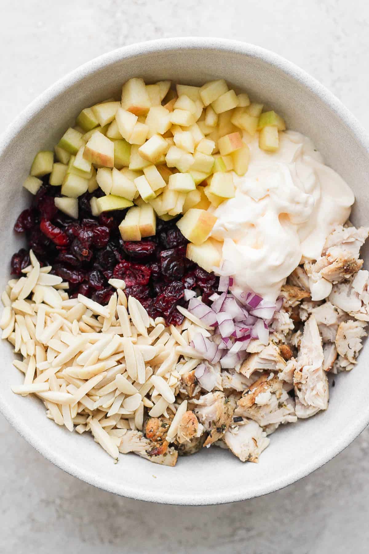 Turkey salad ingredients in a bowl before mixing.