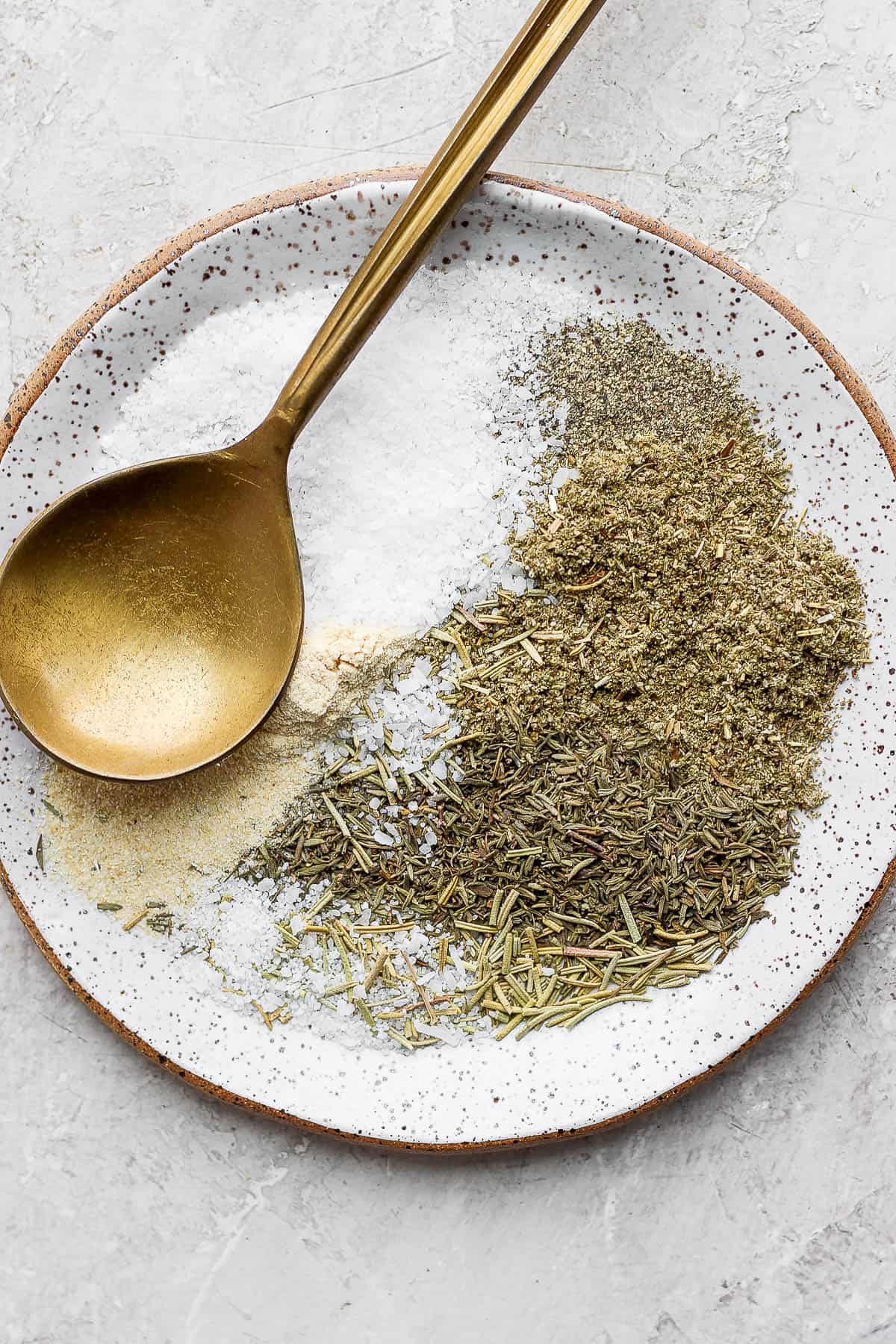 Turkey seasoning spices on a plate with a spoon.