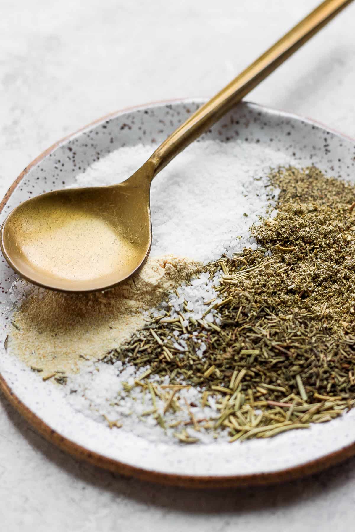 Turkey seasoning spices on a plate with a spoon.