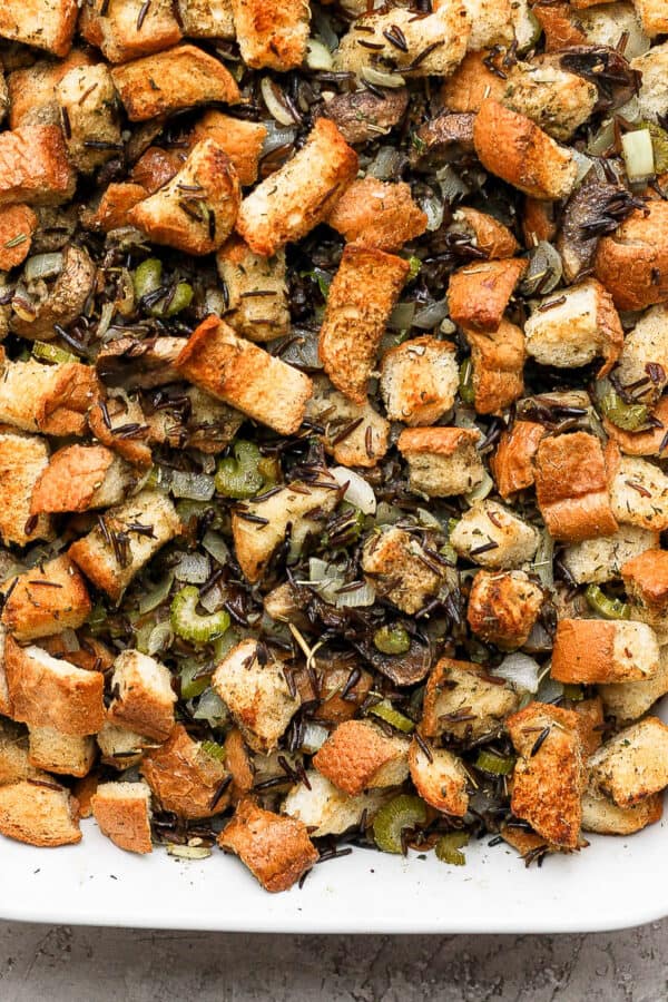 Wild rice stuffing in a white baking dish.