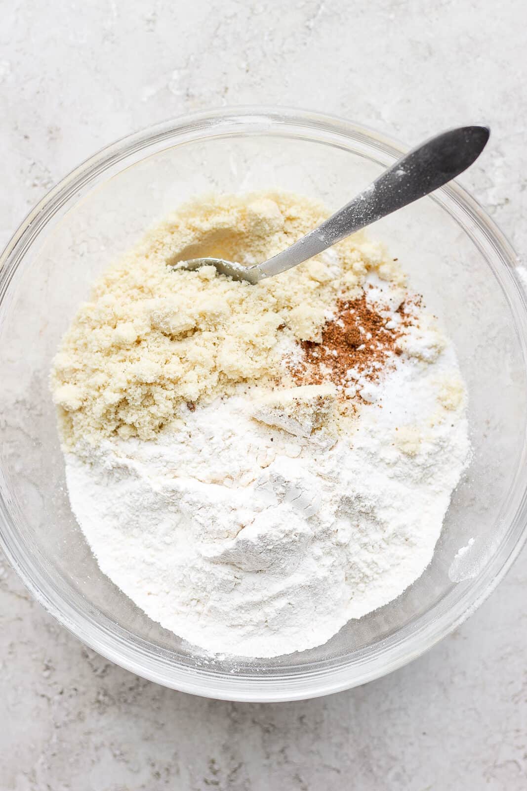 Dry ingredients for almond flour sugar cookies in a mixing bowl.
