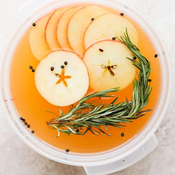 A container full of apple cider turkey brine.