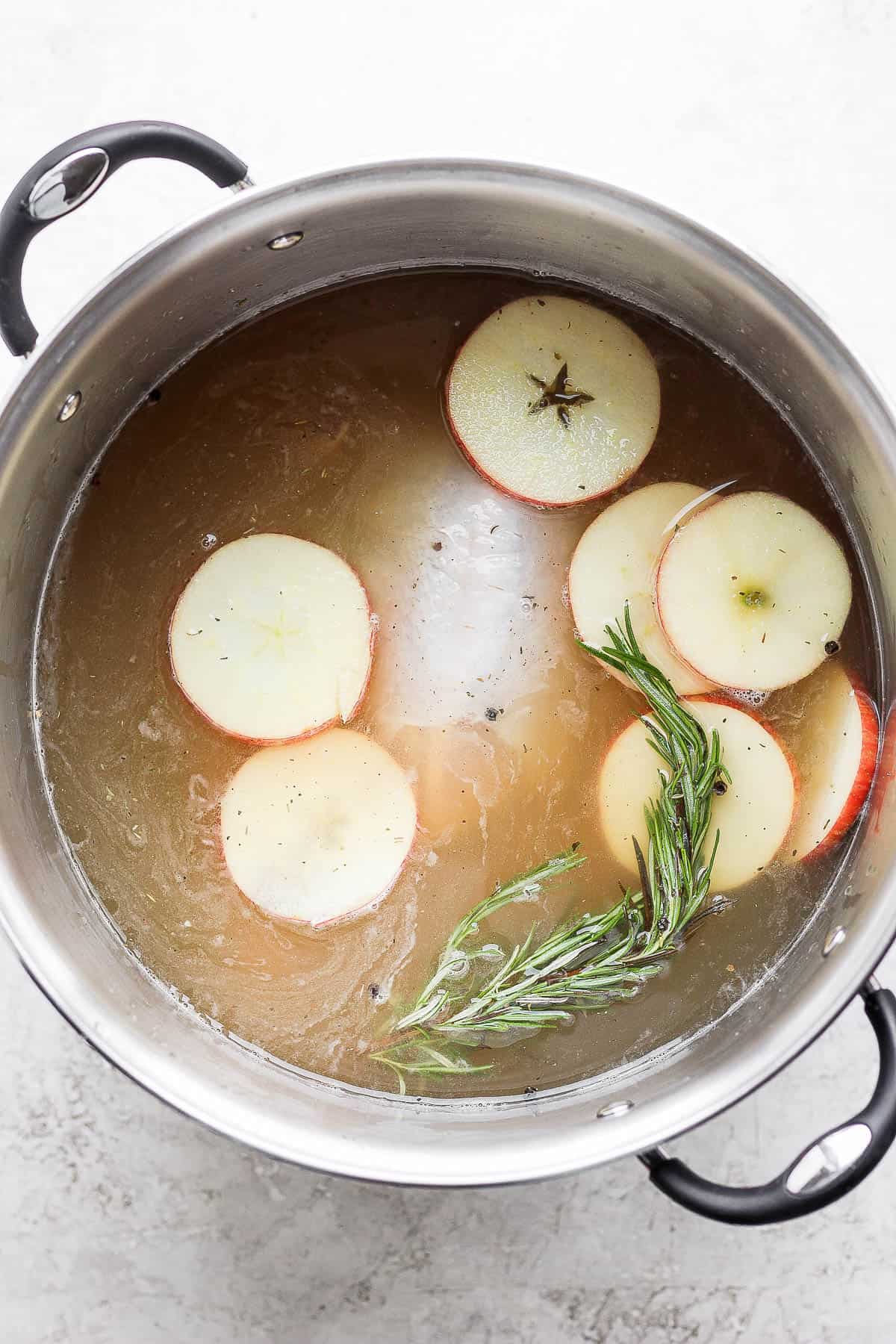 A turkey sitting in an apple cider brine.