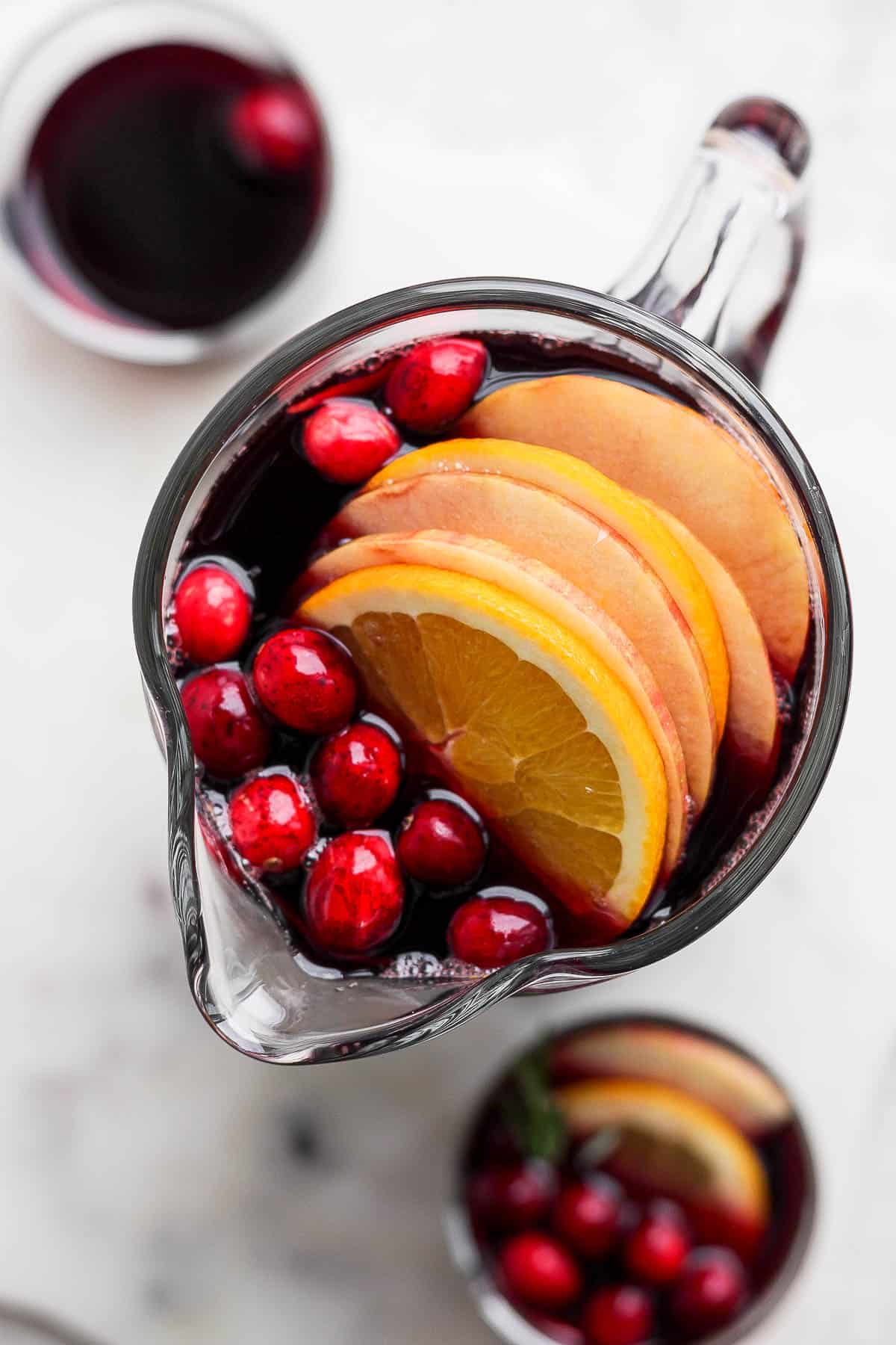 Overhead view of a pitcher of Christmas sangria.