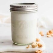 Mason jar of homemade cashew milk.
