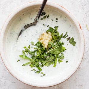 Bowl of lamb sauce with mint and garlic.