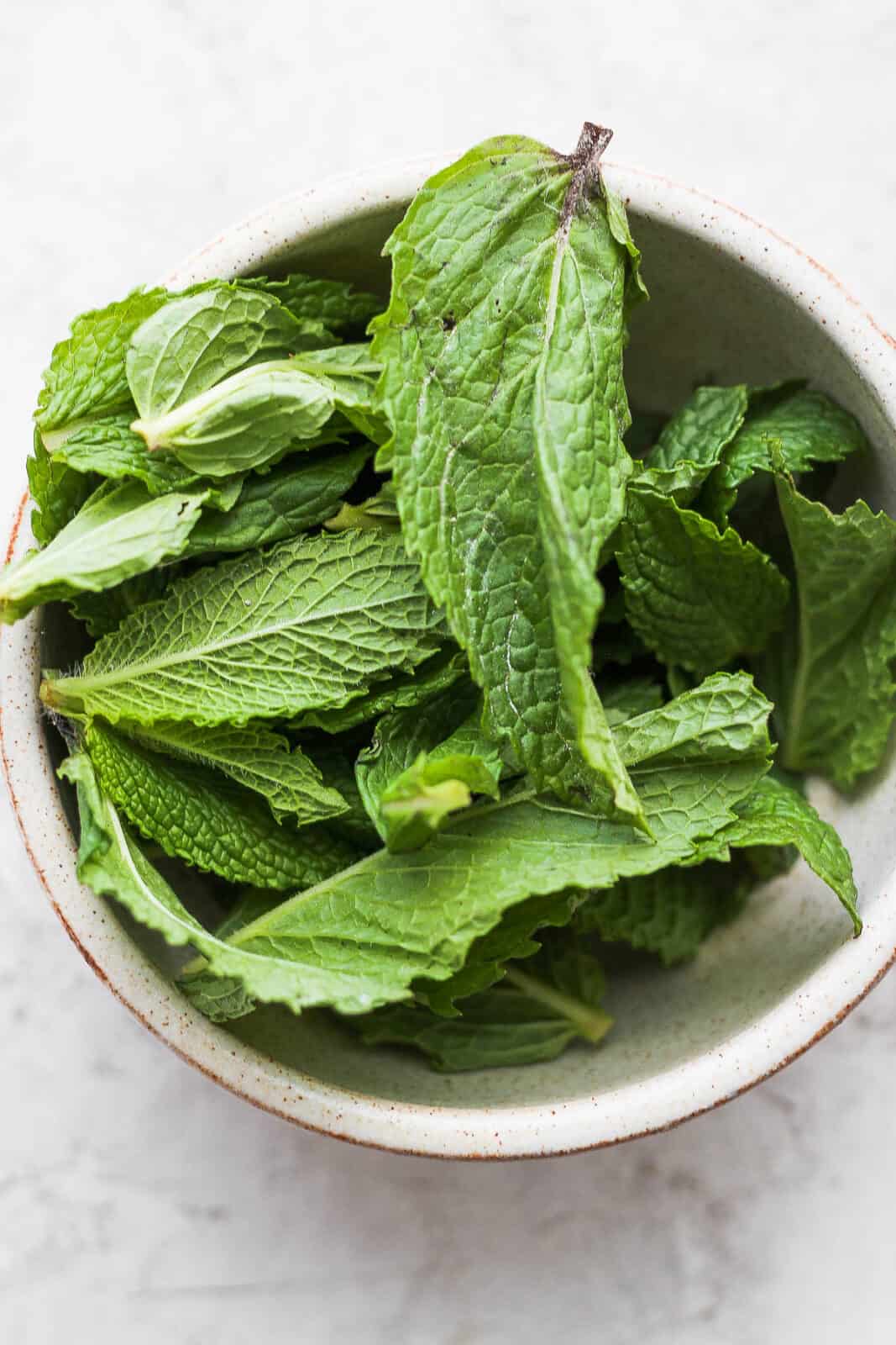 A bowl of mint leaves.