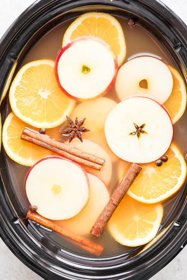 A slow cooker full of spiked apple cider.