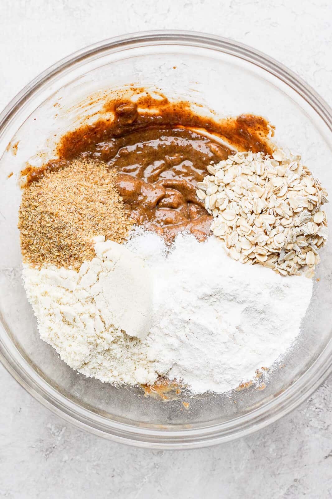 All ingredients for vegan cookie dough in a bowl, except for m&ms and chocolate chips.