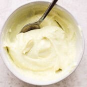 Bowl of wasabi mayo with a spoon in it.