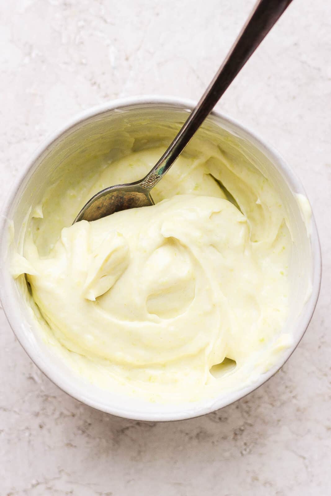 Wasabi mayo in a bowl with a spoon.
