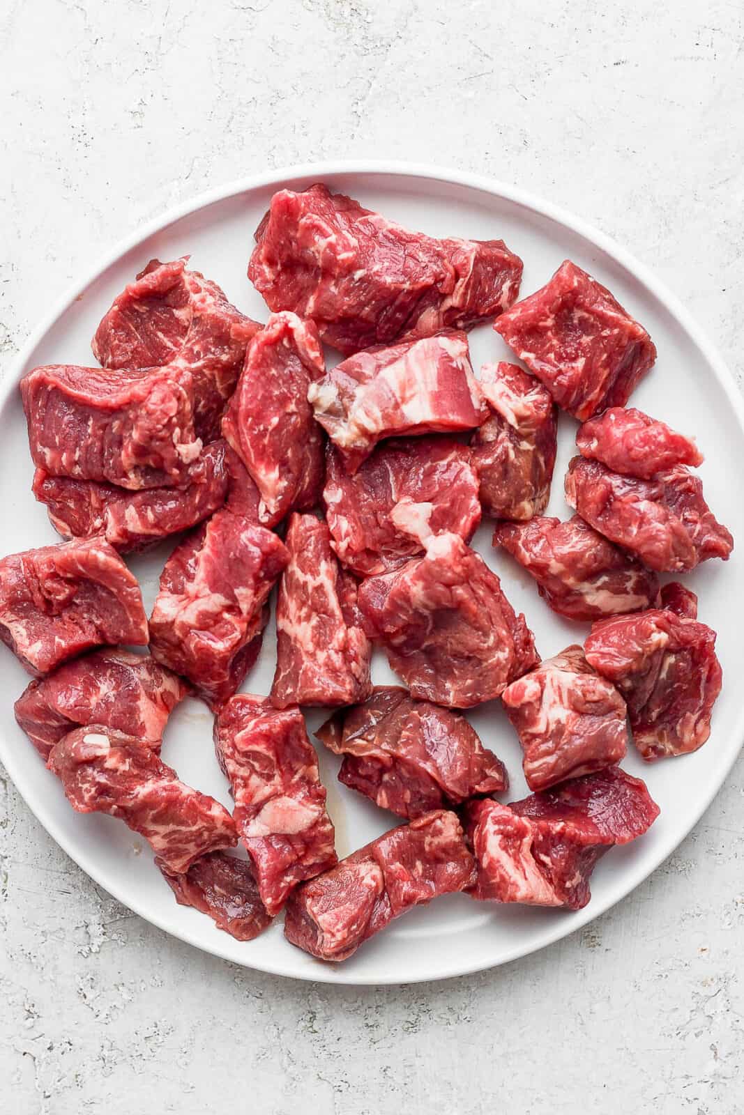 Plate of raw steak bites.