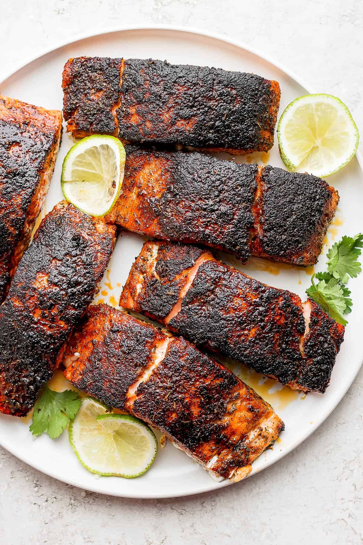 Blackened salmon fillets on a plate.