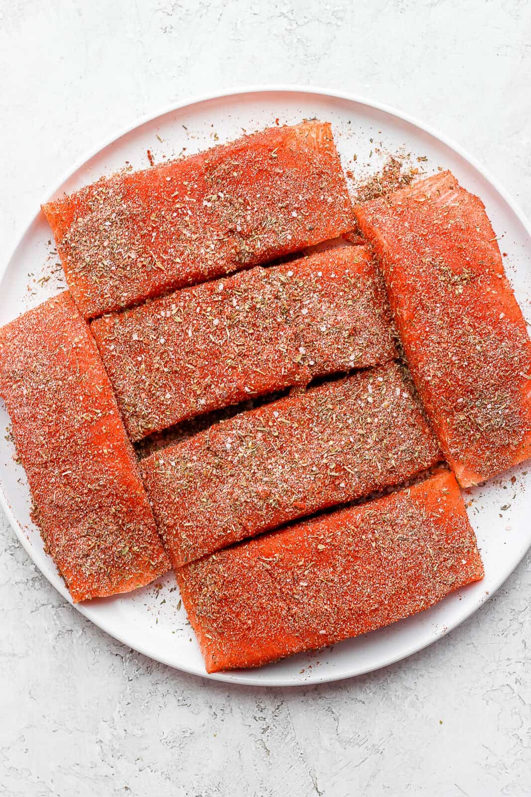 Salmon fillets covered with blackened seasoning.