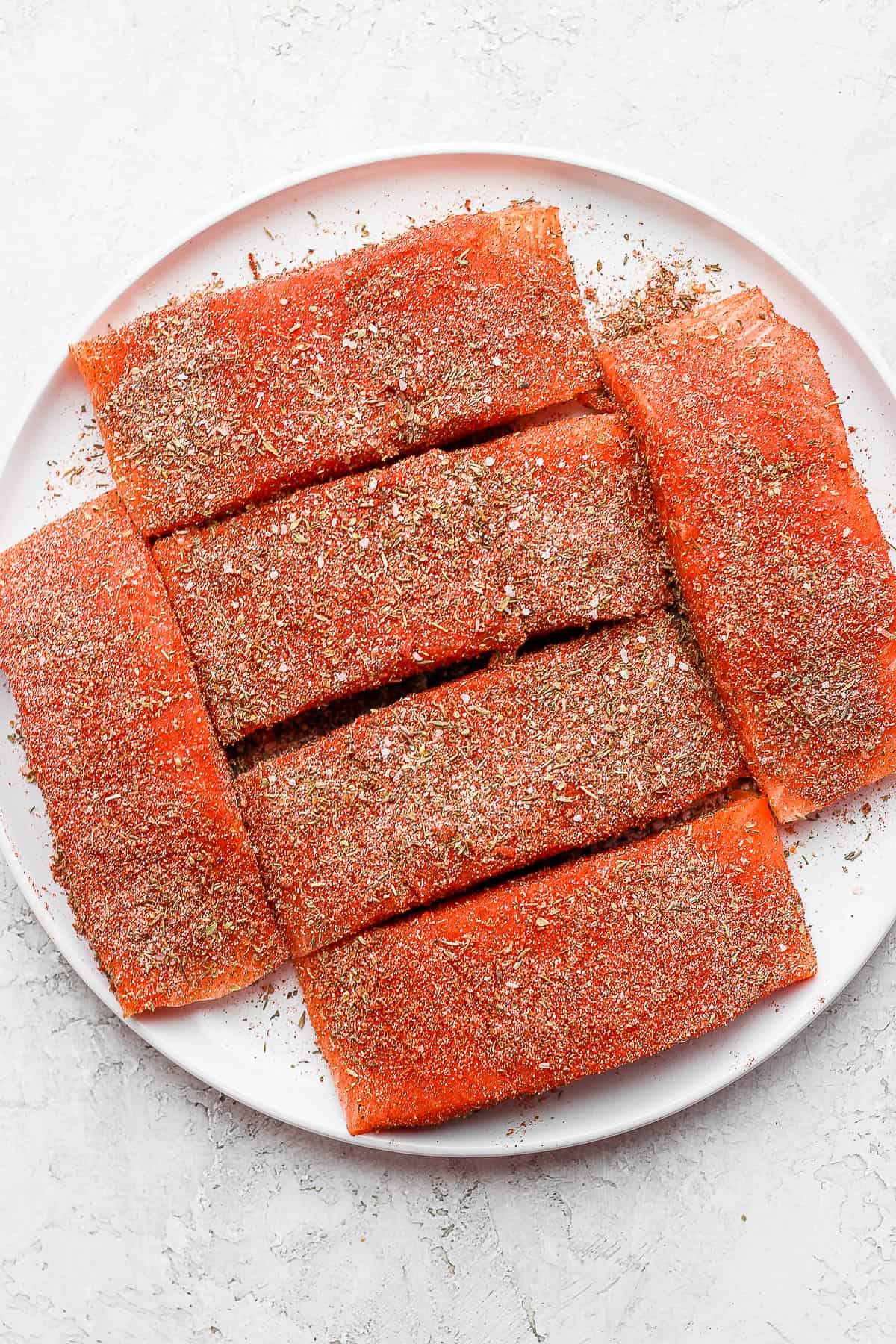 Salmon fillets covered with blackened seasoning.