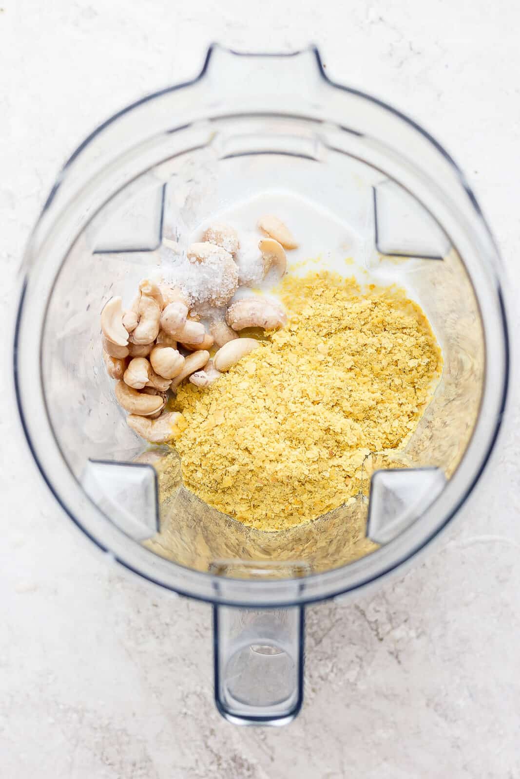 Ingredients for cashew cream added to a blender.