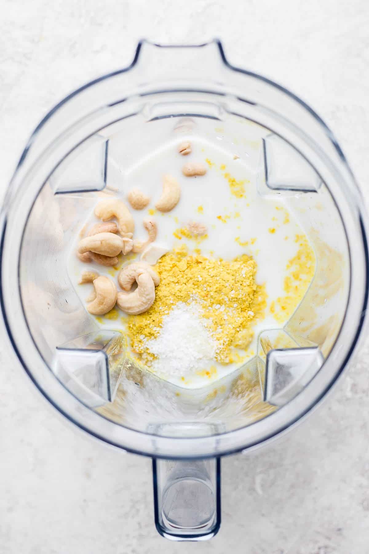 Cashews, almond milk, nutritional yeast, and salt in a blender.