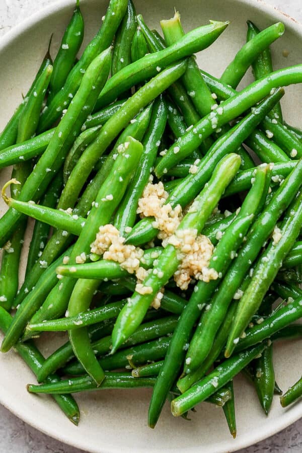 Shallow bowl filled with garlic green beans.