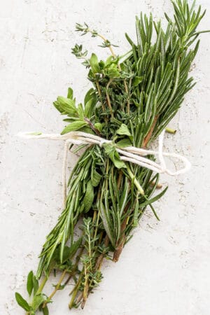 An herb bundle wrapped in cooking twine.