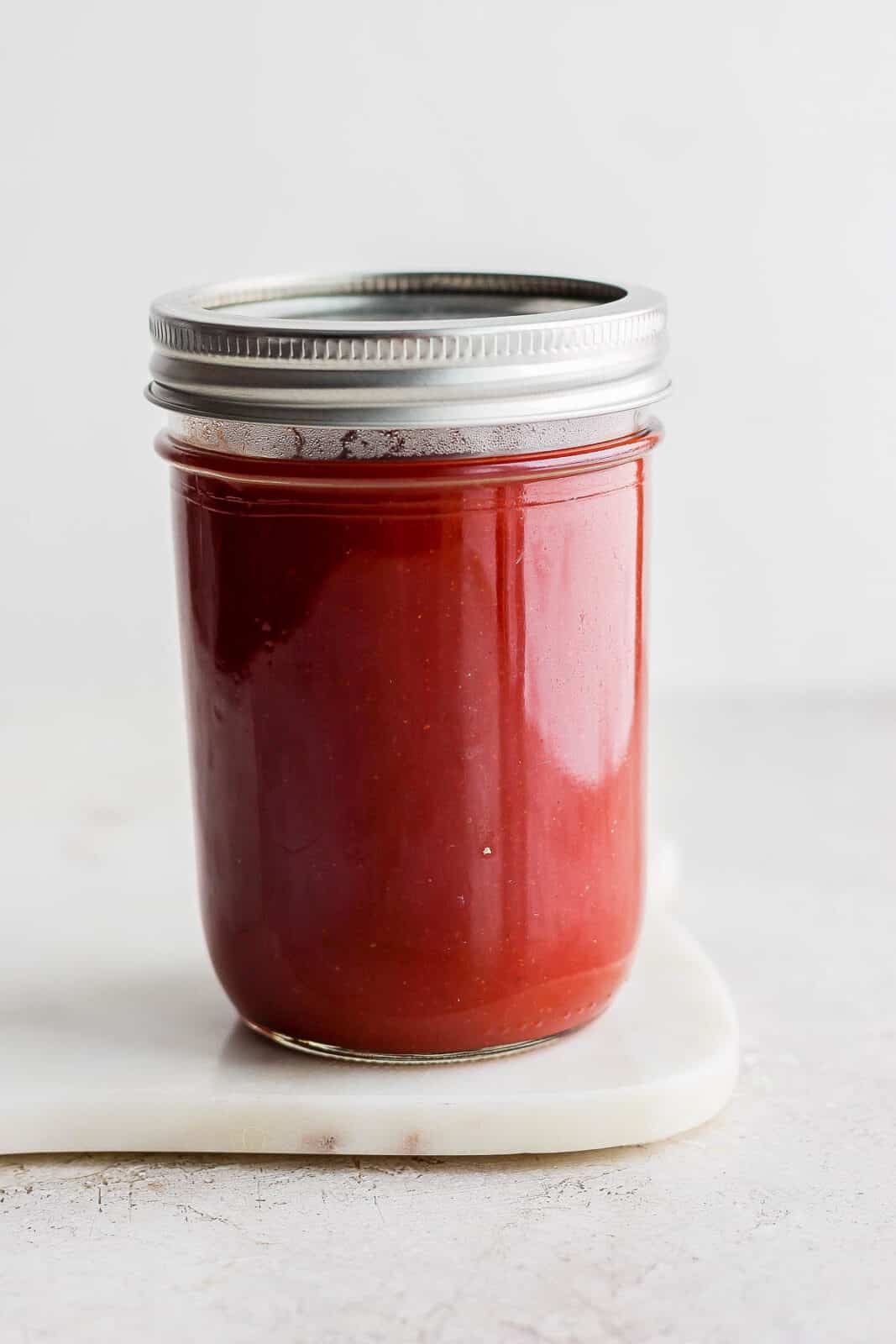 Mason jar full of homemade bbq sauce.