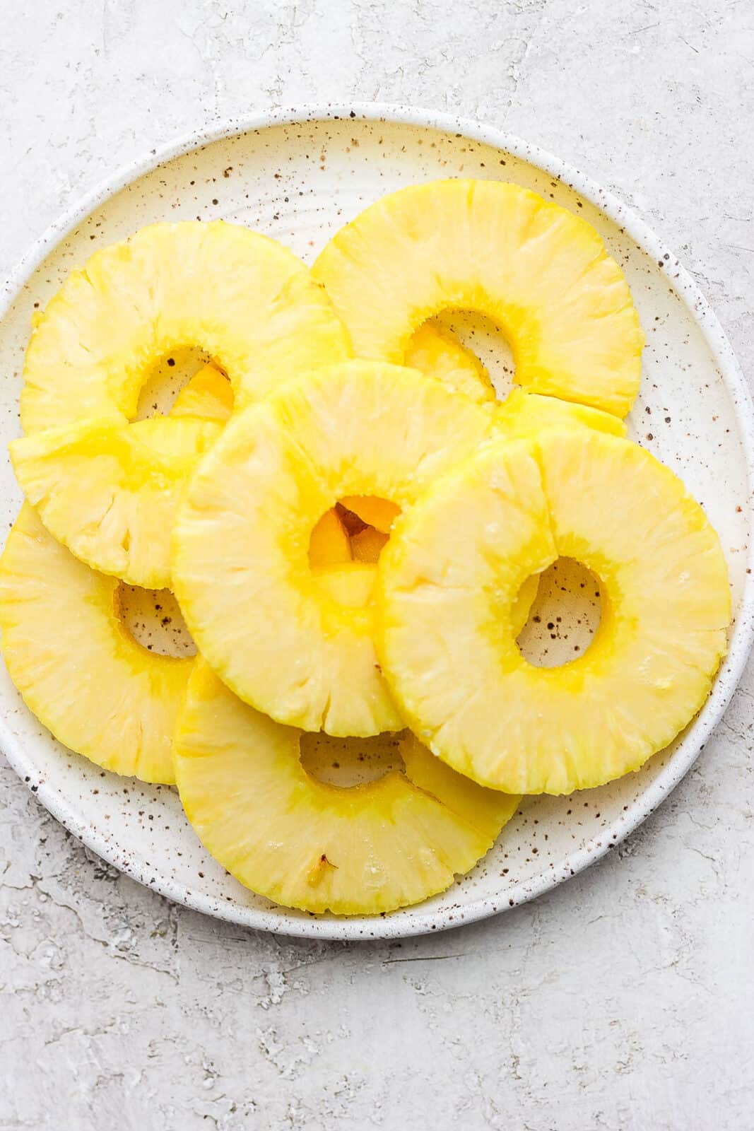 Pineapple slices on a plate.