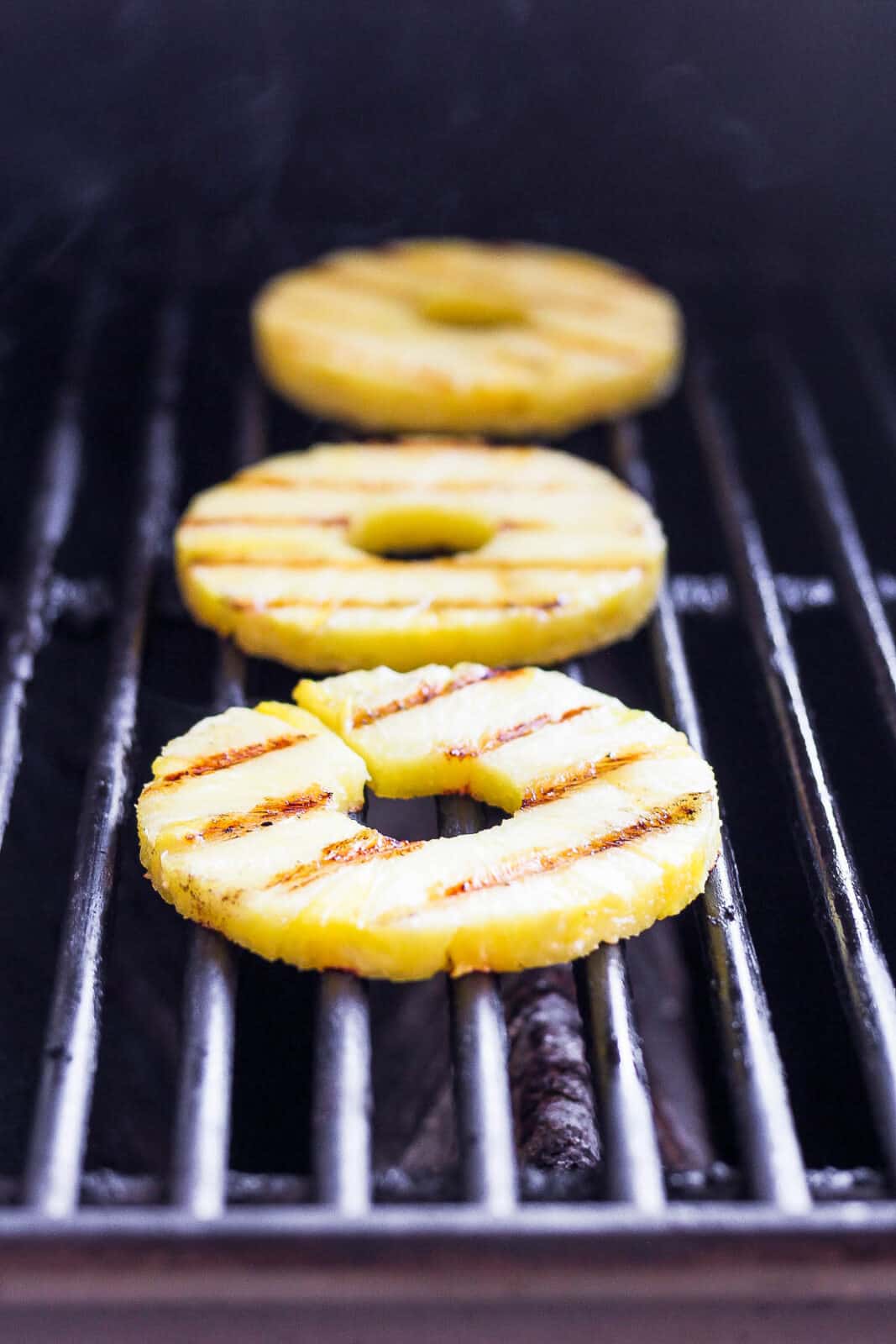 Pineapple slices on the grill.