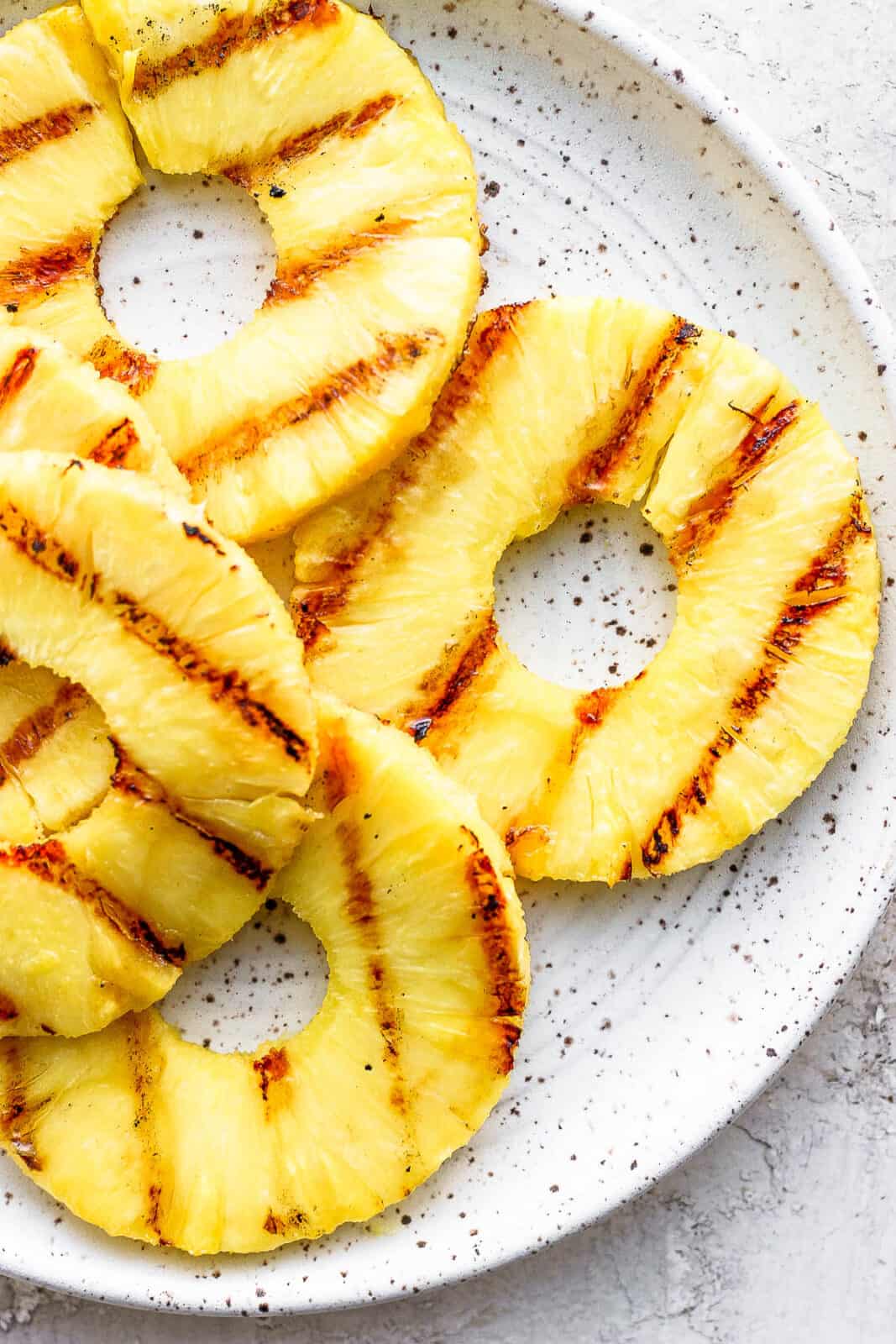 Grilled pineapple on a plate.