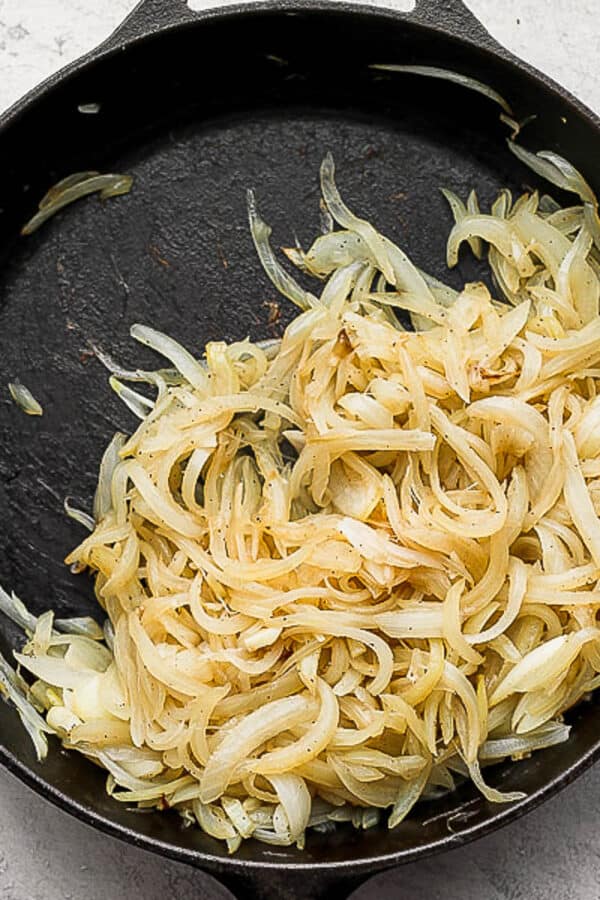 Cast iron skillet full of caramelized onions.