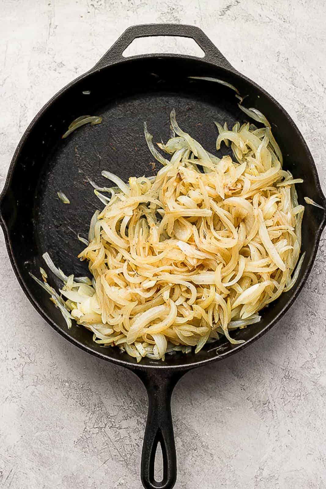 Caramelized onions in a cast iron skillet.