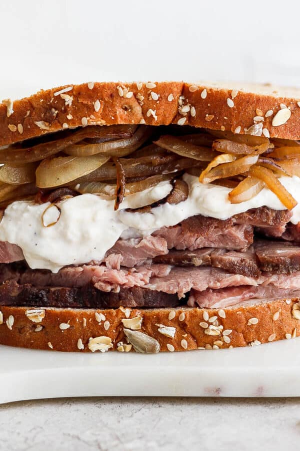 Leftover prime rib sandwich on a marble board.