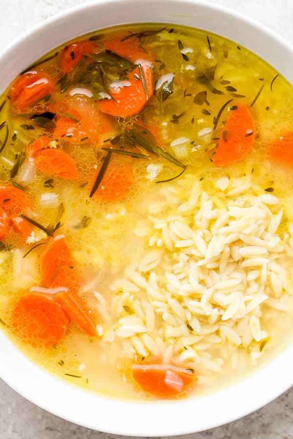 Bowl of lemon chicken orzo soup.