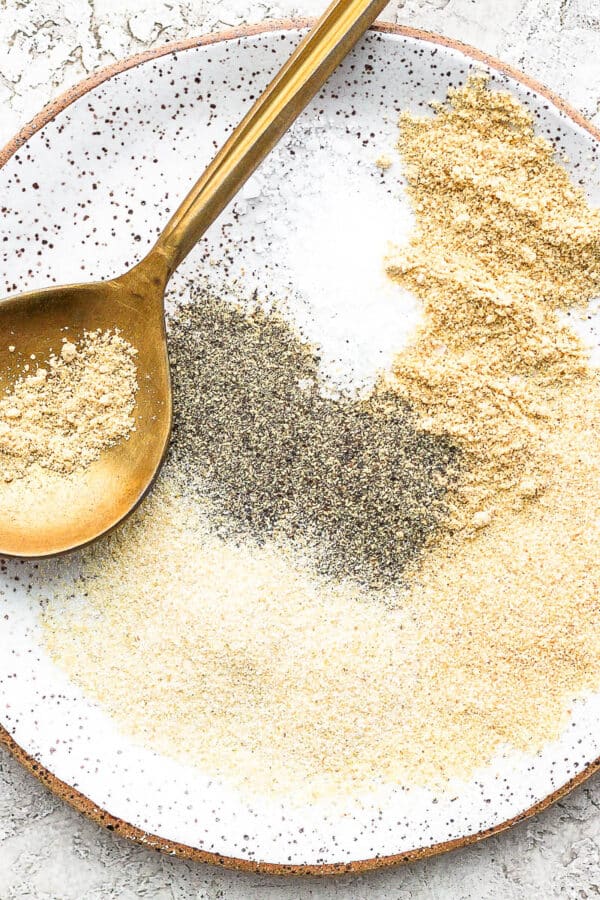 Plate of meatloaf seasoning with golden spoon.