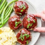 Plate of mini meatloaf muffins, green beans and mashed potatoes.